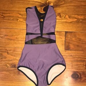 a purple and black Five Dancewear leotard